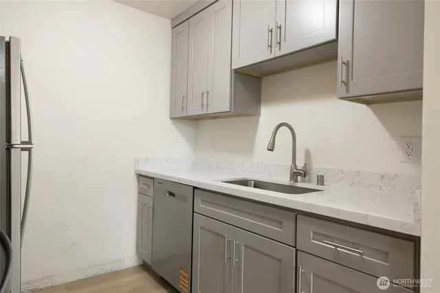 a kitchen with a sink and cabinets