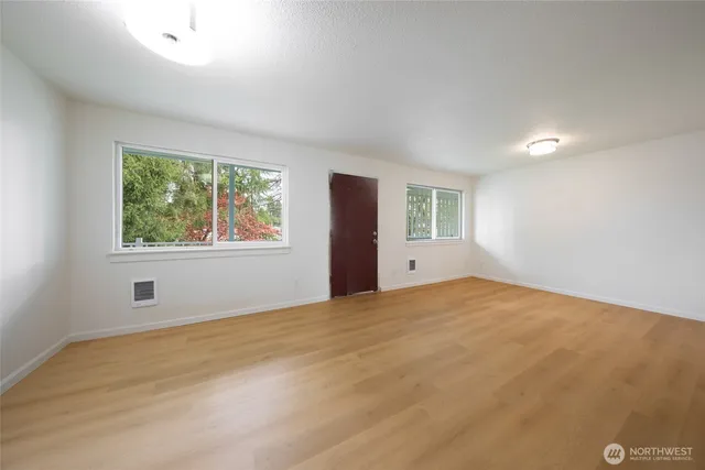 a view of an empty room with windows