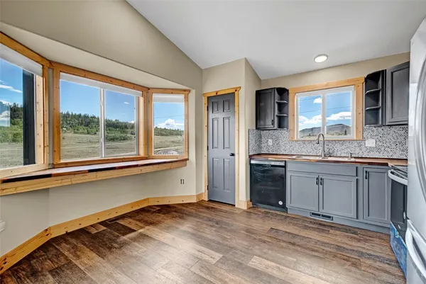 a large kitchen with stainless steel appliances granite countertop a stove and a sink