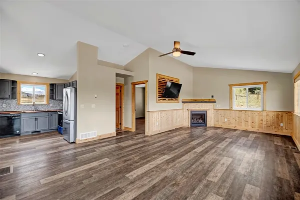 a view of a kitchen with wooden floor and a window