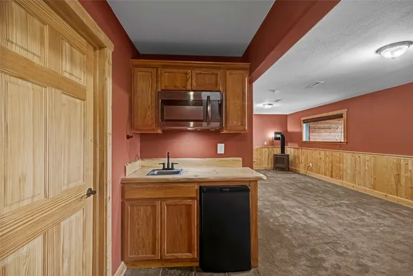 a kitchen with stainless steel appliances granite countertop a stove a sink and a microwave