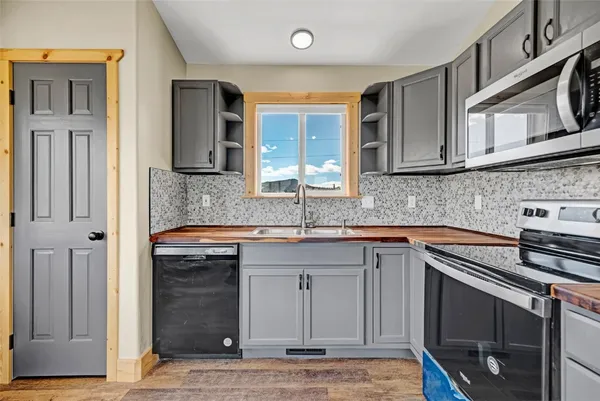 a kitchen with stainless steel appliances granite countertop a sink stove and cabinets
