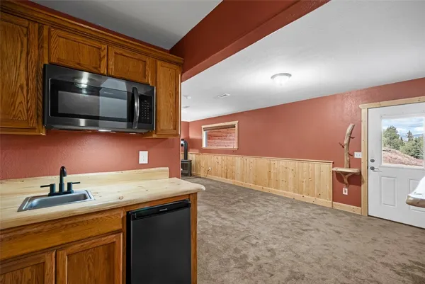 a kitchen with a sink a stove and microwave