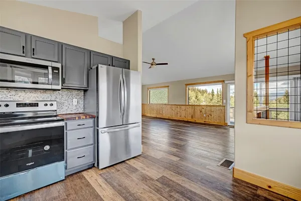 a kitchen with stainless steel appliances granite countertop a refrigerator microwave and stove top oven