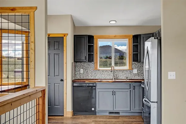 a view of kitchen with granite countertop cabinets and window