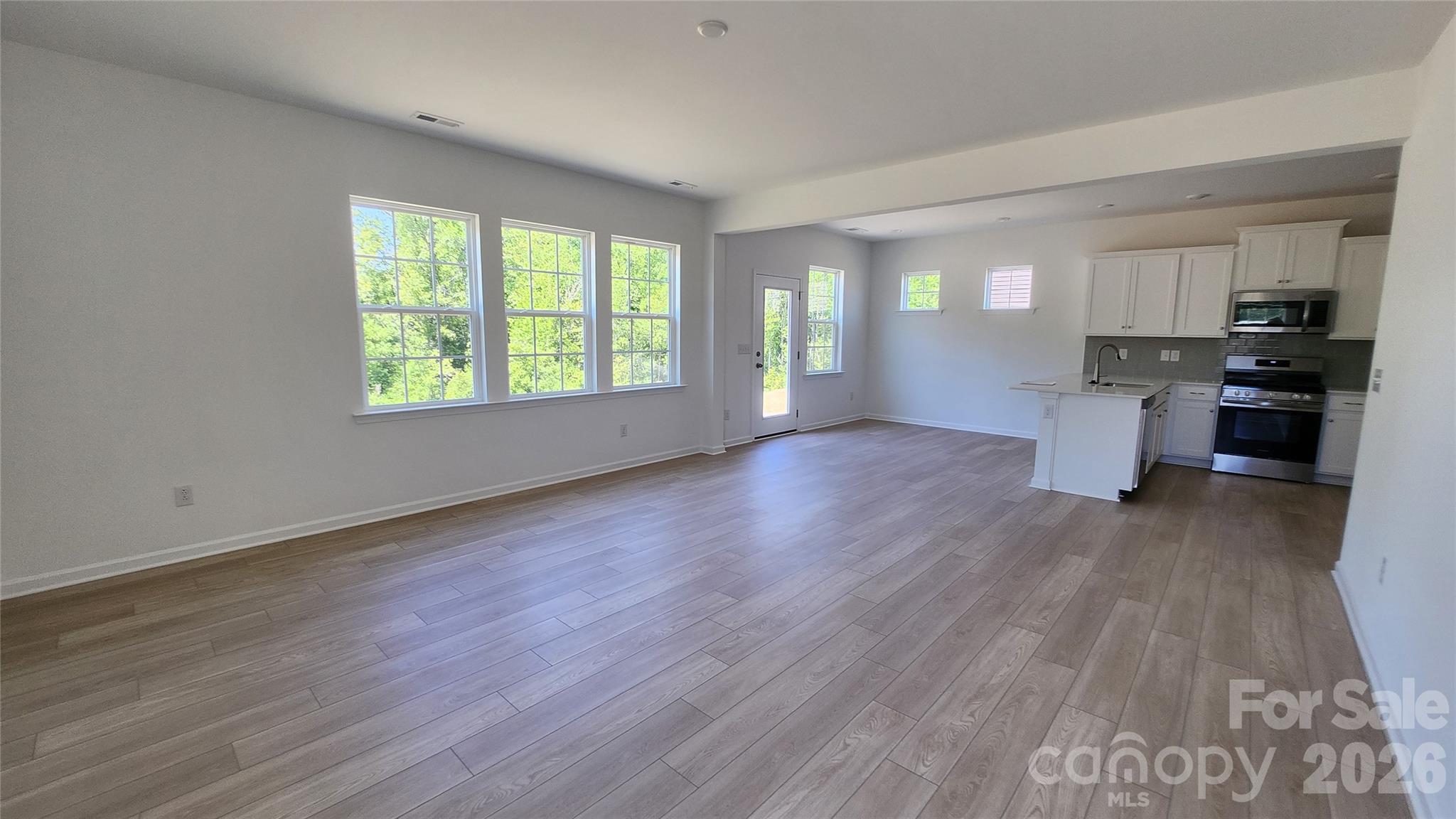 7002 Juneberry Way Maiden, NC 28650 - Photo 4 of 25 an empty room with wooden floor and windows