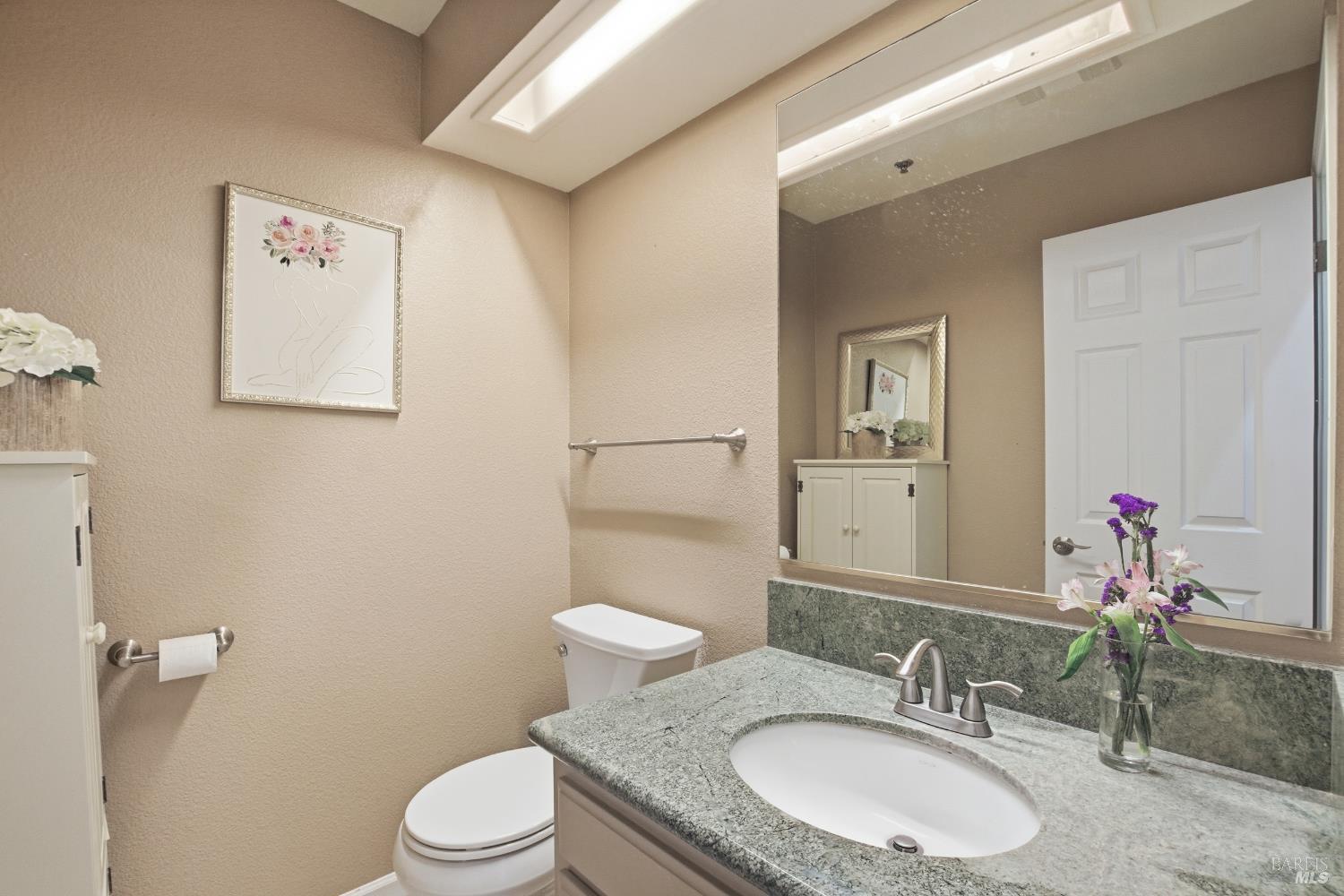 2003 Stonefield Lane Santa Rosa, CA 95403 - Photo 14 of 25 a bathroom with a granite countertop sink toilet a large mirror and a shower