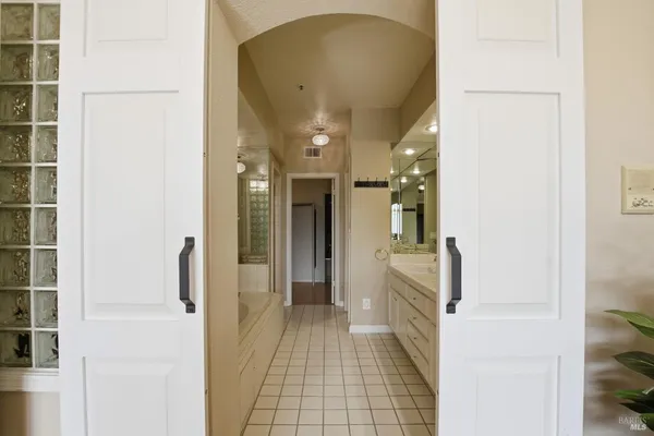a bathroom with a double vanity sink a large mirror and a shower