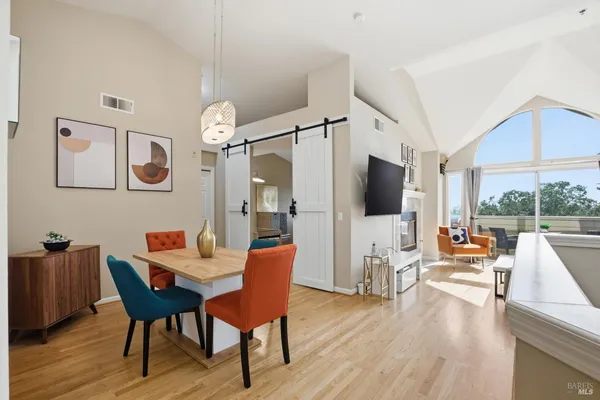 a view of a dining room with furniture and wooden floor