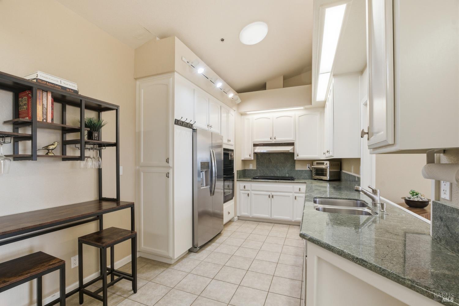 2003 Stonefield Lane Santa Rosa, CA 95403 - Photo 7 of 25 a kitchen with stainless steel appliances granite countertop a refrigerator and a sink