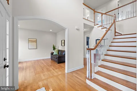 a view of entryway and hall with wooden floor