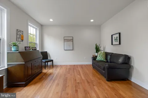 a living room with furniture and a wooden floor