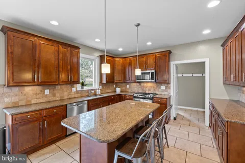a kitchen with granite countertop lots of counter space and window