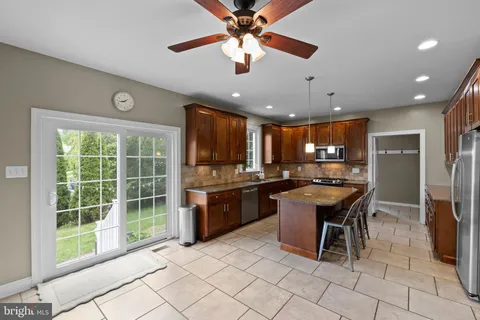 a kitchen with a sink dining table and chairs