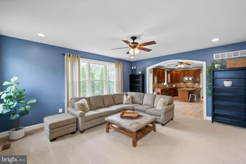 a living room with furniture and flowers