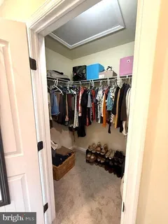 a bathroom with double vanity sinks a toilet and a mirror