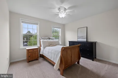 a bedroom with a bed and a flat tv screen on the dresser