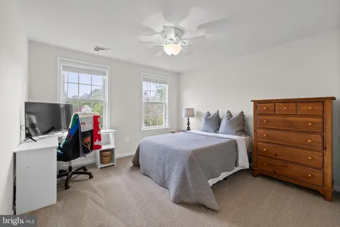 a bedroom with a white bed and a chandelier