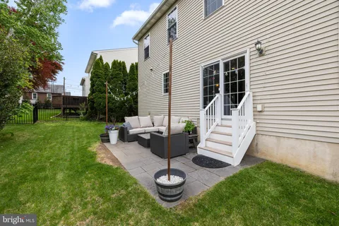 a view of a patio with couches chairs and a fire pit