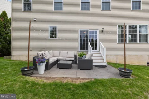 a view of backyard with seating space and plants