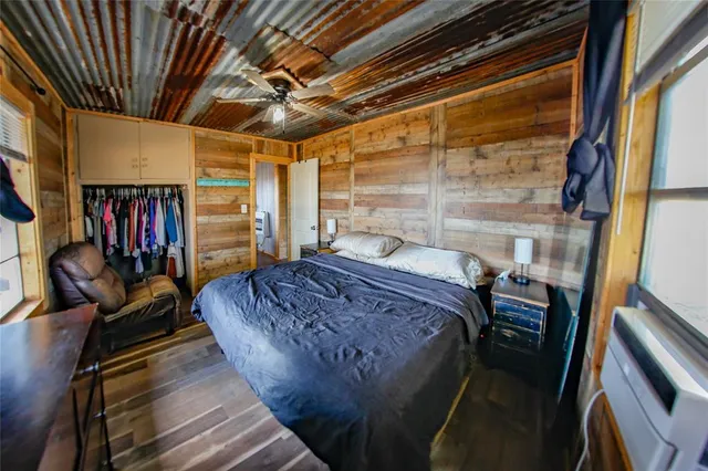 a bed sitting in a bedroom next to a window