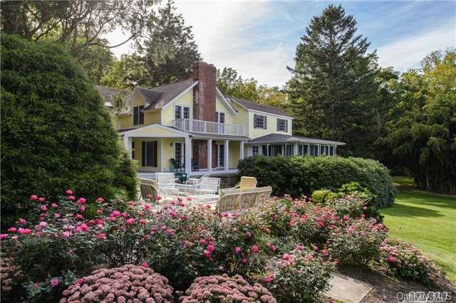 a front view of a house with a yard and fountain