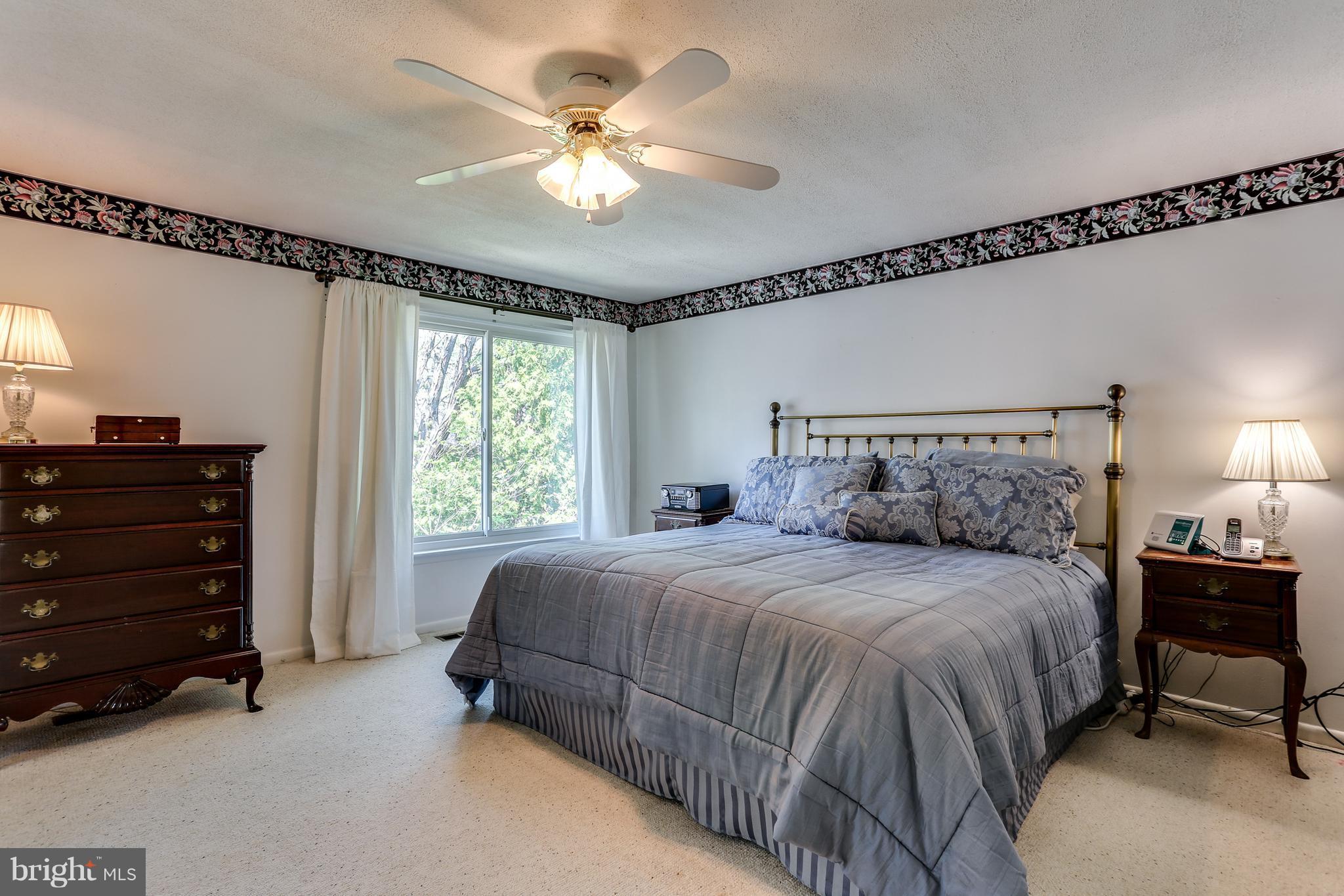 5431 Vantage Point Road Columbia, MD 21044 - Photo 14 of 29 a bedroom with a bed a chandelier and a dresser