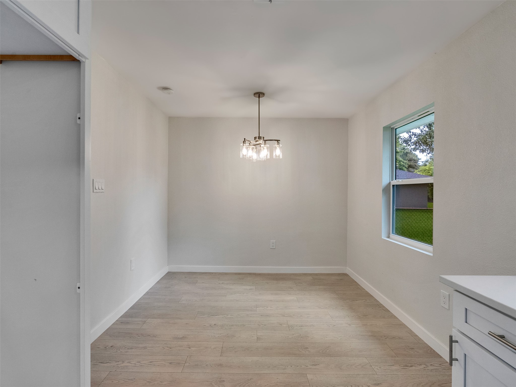 10315 Winding Trail Road La Porte, TX 77571 - Photo 10 of 24 Bright and inviting, this breakfast area boasts chic lighting and a large window that brings in natural light, perfect for morning gatherings.