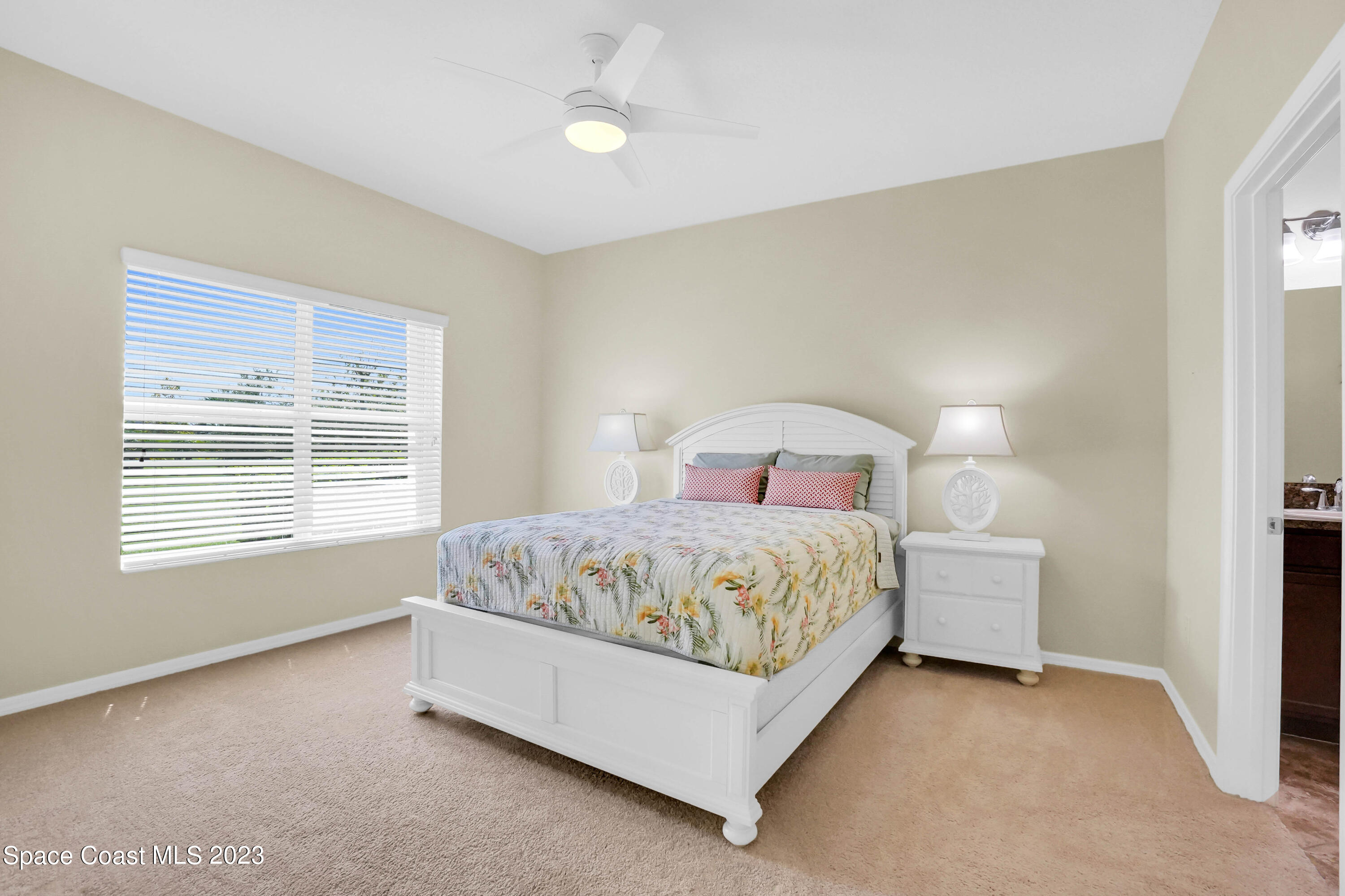 5928 Van Ness Drive Melbourne, FL 32940 - Photo 18 of 35 a bedroom with a bed and a window