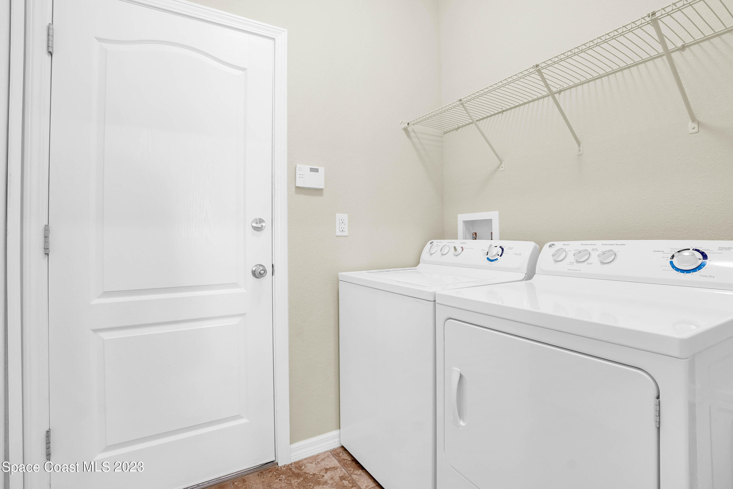 5928 Van Ness Drive Melbourne, FL 32940 - Photo 21 of 35 a utility room with dryer and washer