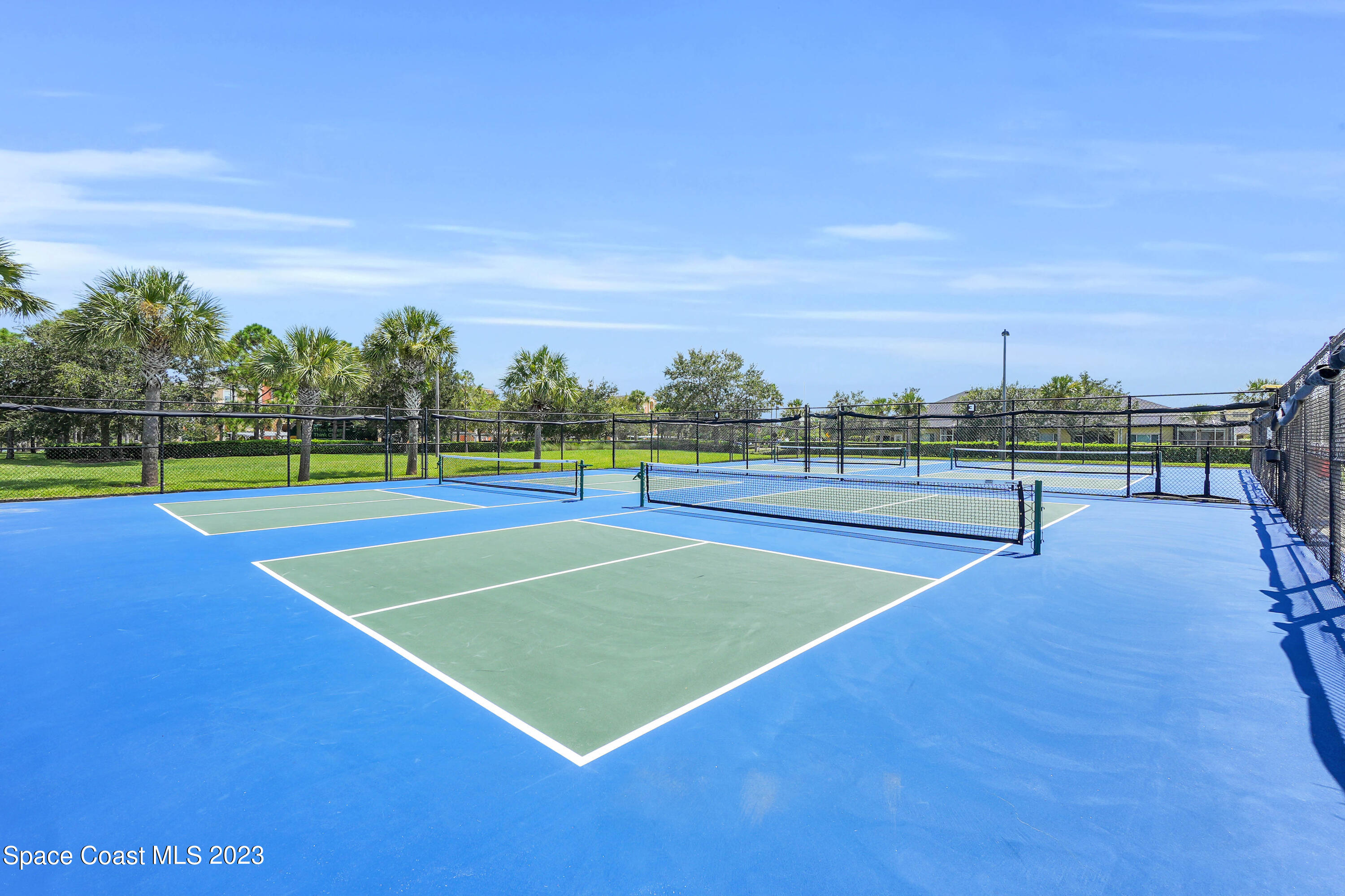 5928 Van Ness Drive Melbourne, FL 32940 - Photo 27 of 35 a view of tennis court with trees in the background