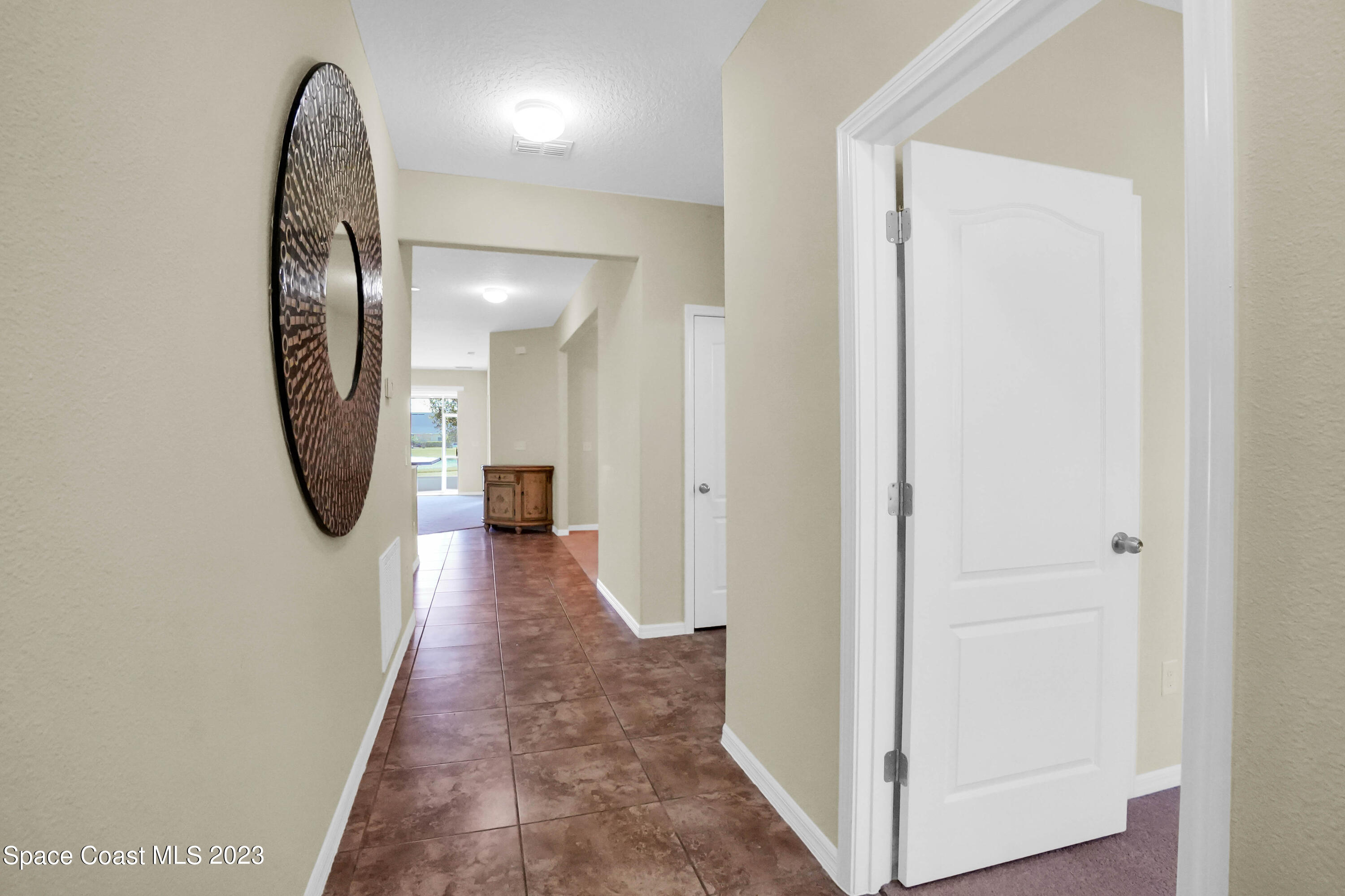 5928 Van Ness Drive Melbourne, FL 32940 - Photo 8 of 35 a view of a hallway with wooden floor