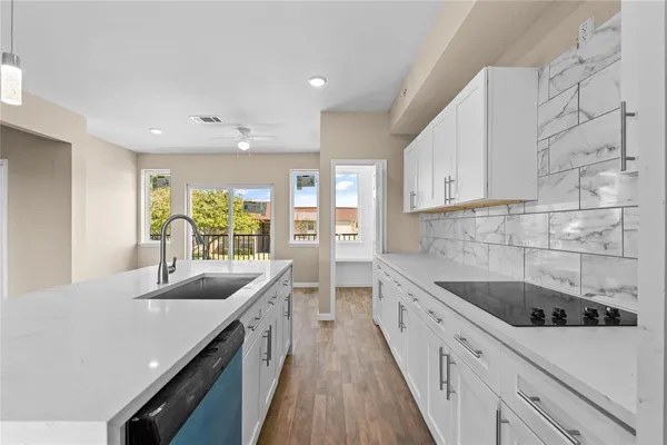 a kitchen with a sink stove and cabinets