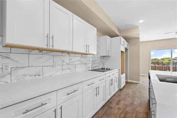 a kitchen with a sink stove and cabinets