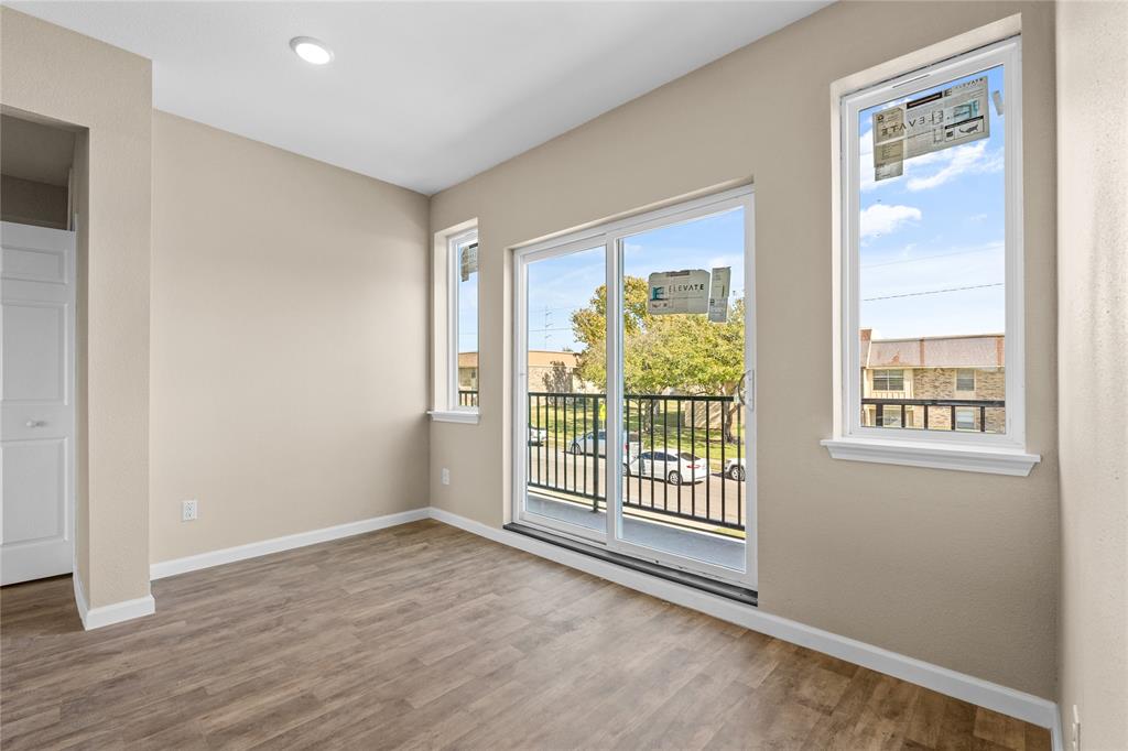 3607 Portland Street Irving, TX 75062 - Photo 19 of 25 an empty room with wooden floor and windows