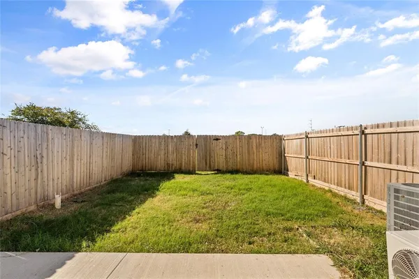 a view of a backyard with wooden fence