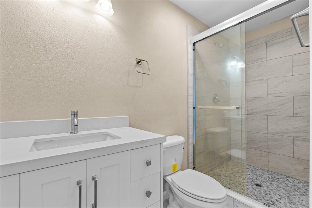 3607 Portland Street Irving, TX 75062 - Photo 6 of 25 a bathroom with a sink a toilet and shower