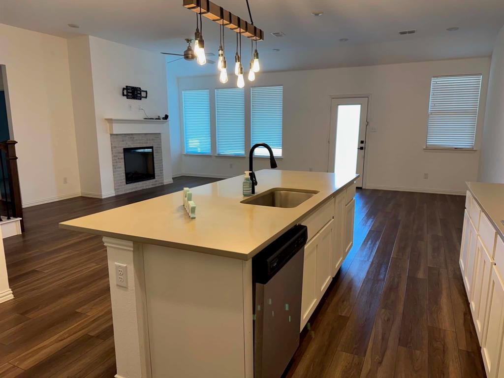 512 Virginia Way Princeton, TX 75407 - Photo 11 of 30 a kitchen with a sink and wooden floor