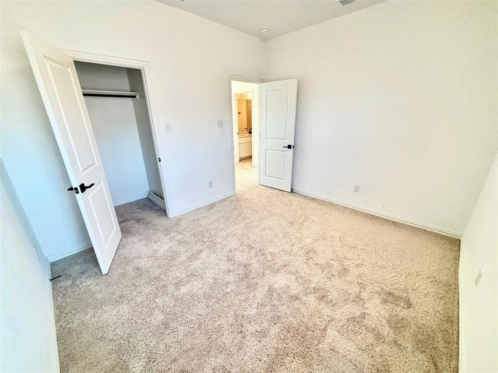 512 Virginia Way Princeton, TX 75407 - Photo 13 of 30 an empty room with a door