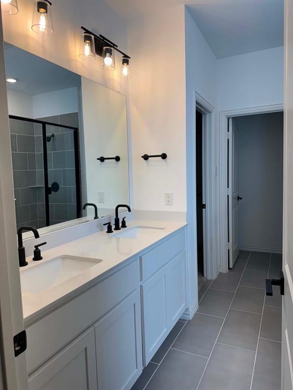 512 Virginia Way Princeton, TX 75407 - Photo 14 of 30 a bathroom with a sink and a mirror