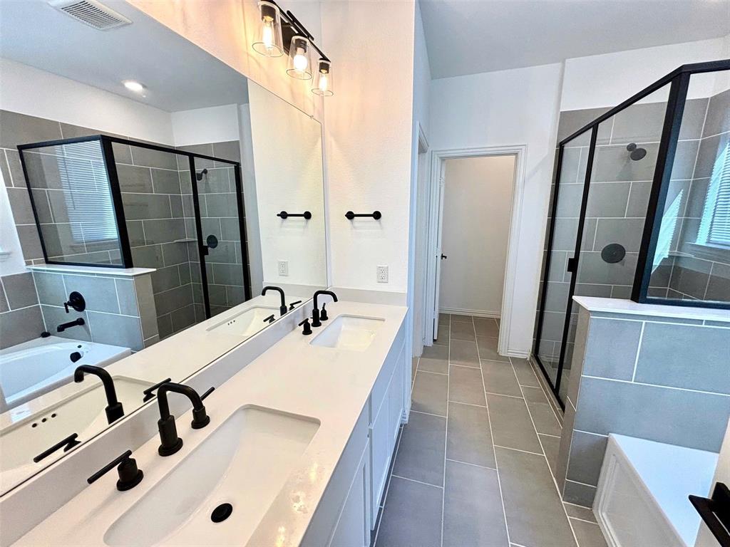 512 Virginia Way Princeton, TX 75407 - Photo 15 of 30 a bathroom with a tub sink and mirror