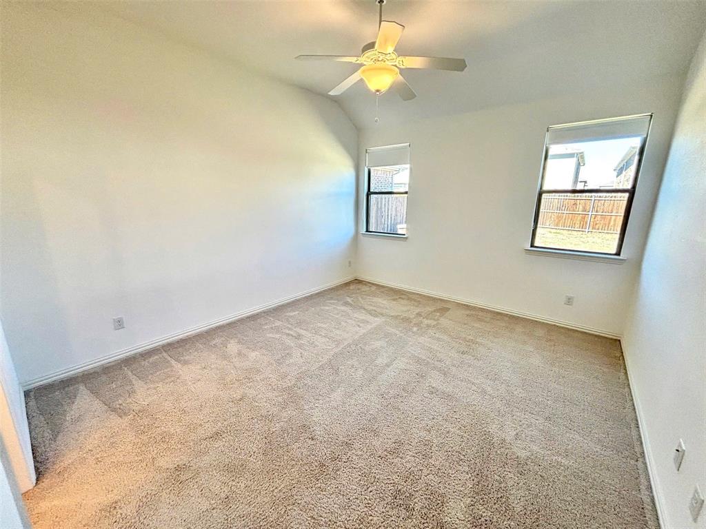 512 Virginia Way Princeton, TX 75407 - Photo 22 of 30 an empty room with windows and fan
