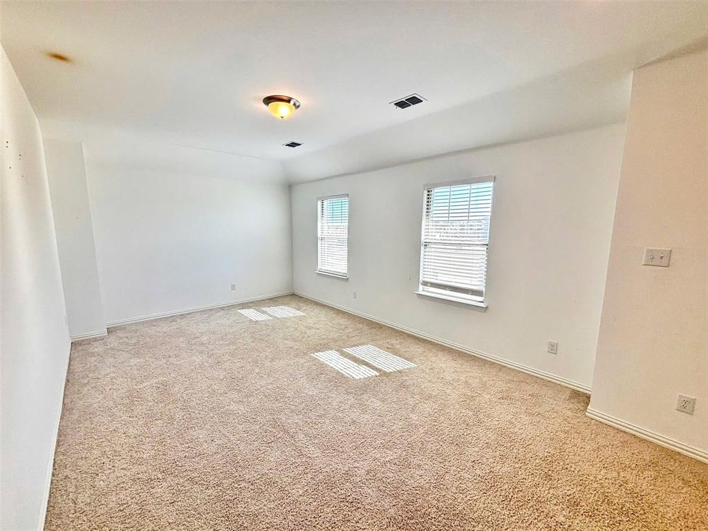 512 Virginia Way Princeton, TX 75407 - Photo 27 of 30 an empty room with windows and cabinet