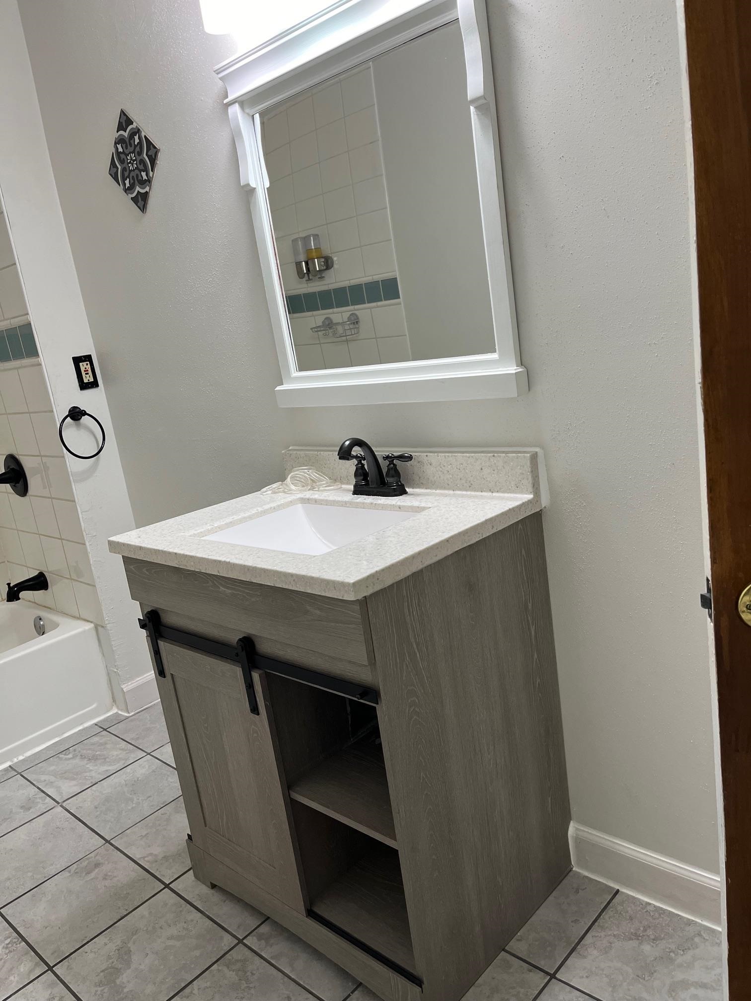 4909 Mohawk Road Rockford, IL 61107 - Photo 17 of 44 a bathroom with a sink and a mirror