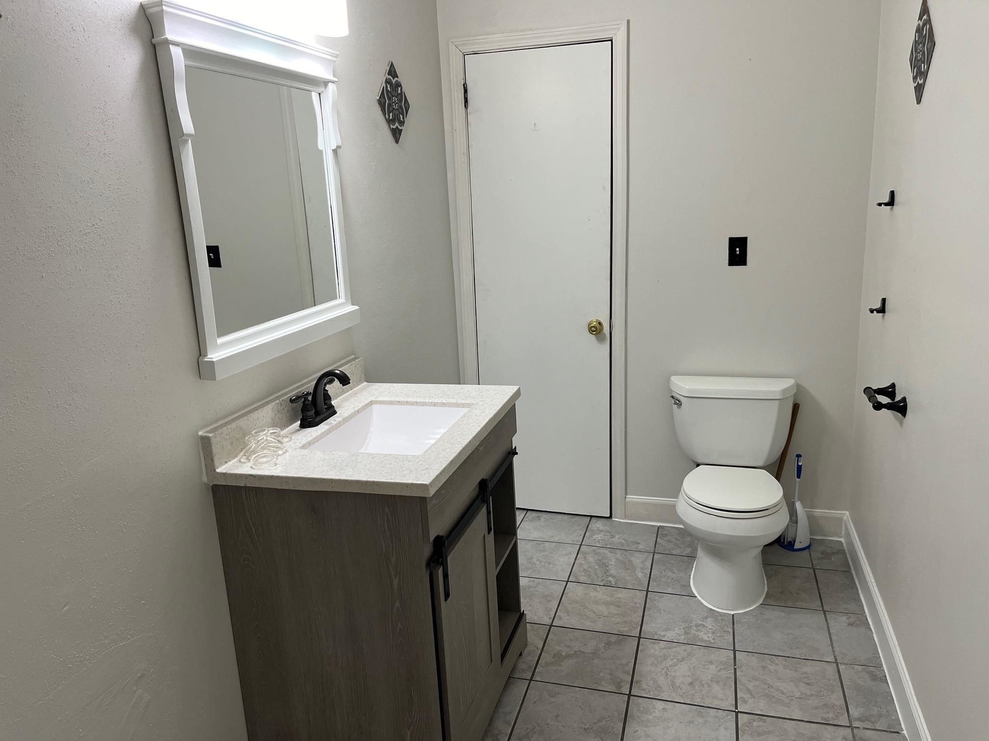 4909 Mohawk Road Rockford, IL 61107 - Photo 18 of 44 a bathroom with a toilet sink and mirror
