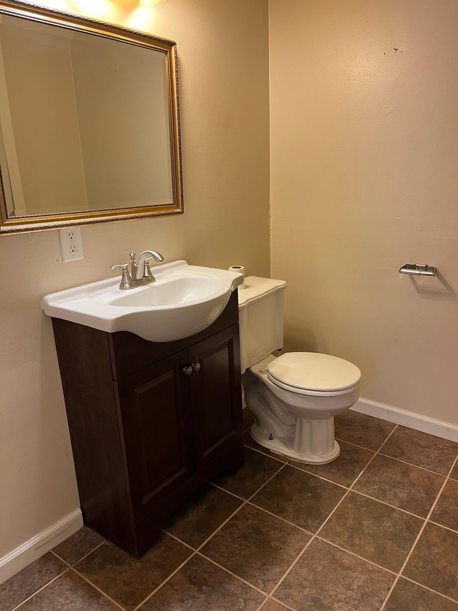 4909 Mohawk Road Rockford, IL 61107 - Photo 29 of 44 a bathroom with a sink toilet and mirror