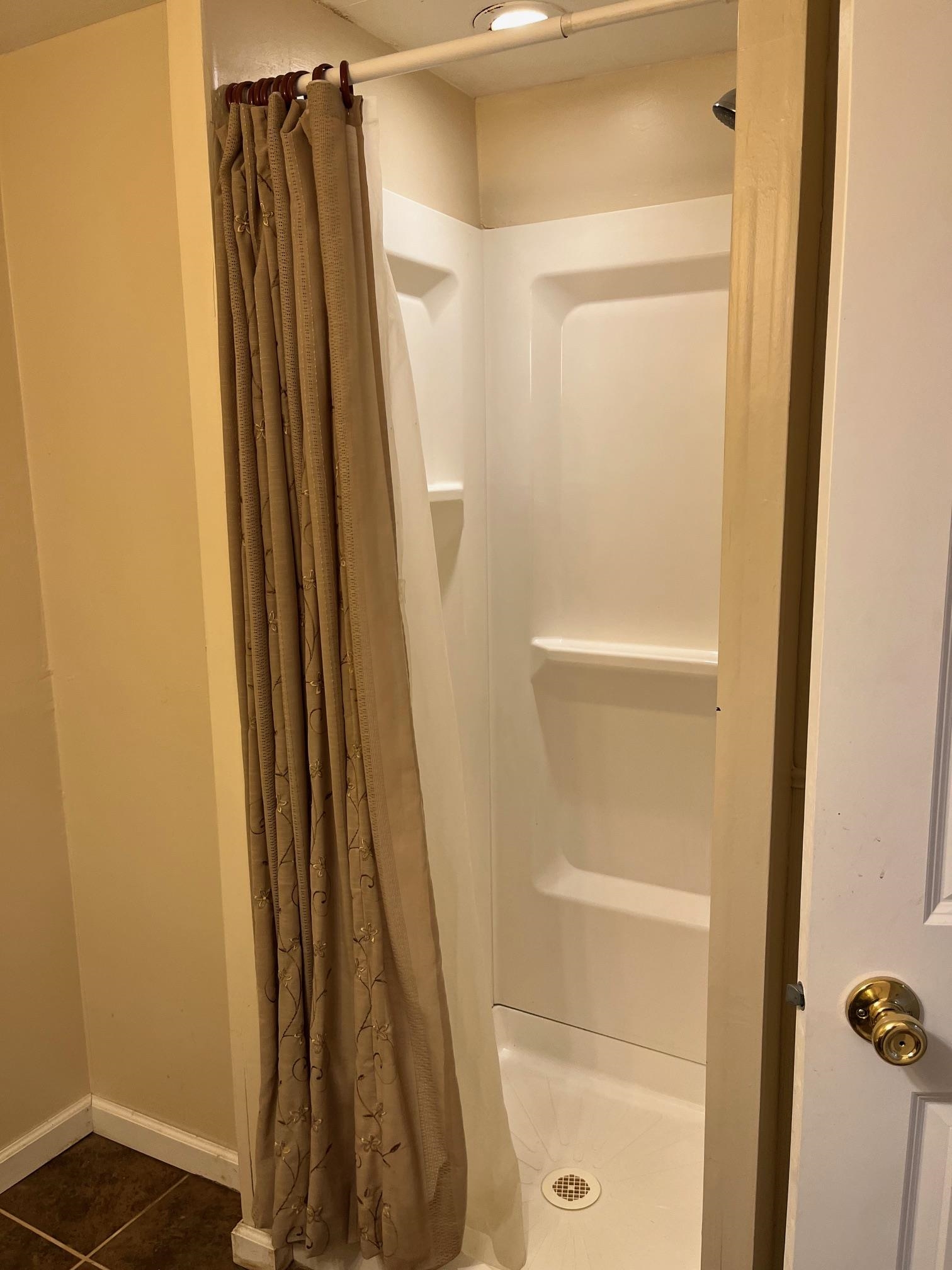 4909 Mohawk Road Rockford, IL 61107 - Photo 31 of 44 a bathroom with a shower and a glass door