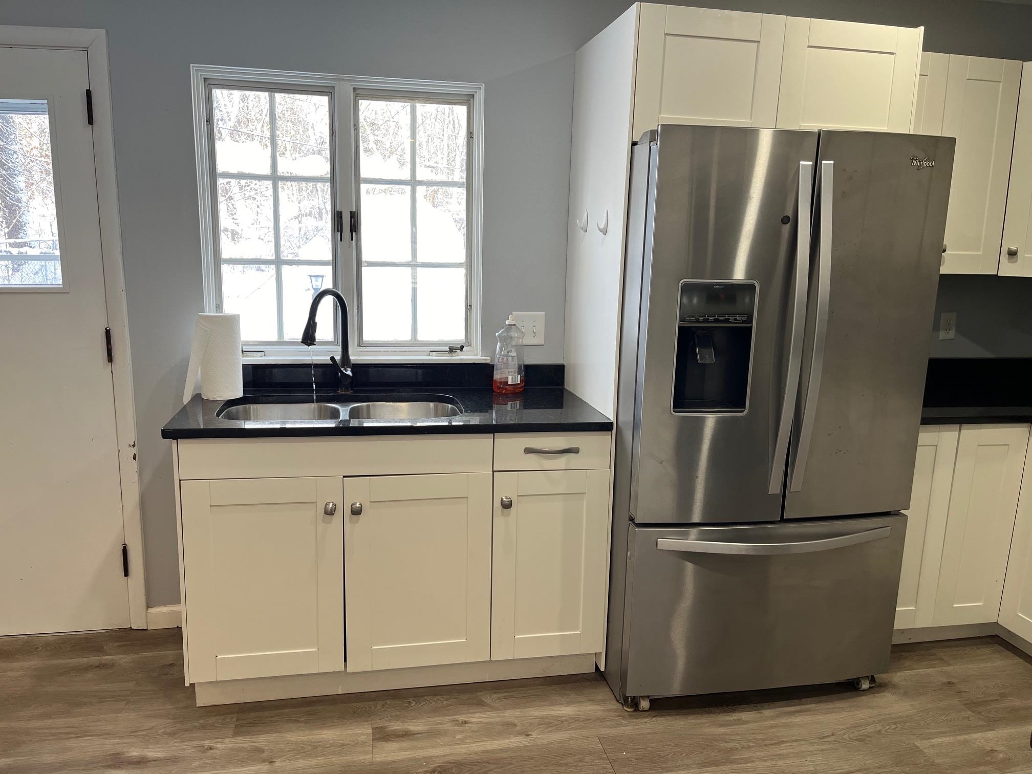 4909 Mohawk Road Rockford, IL 61107 - Photo 5 of 44 a kitchen with stainless steel appliances granite countertop a refrigerator a sink a stove a washer and dryer
