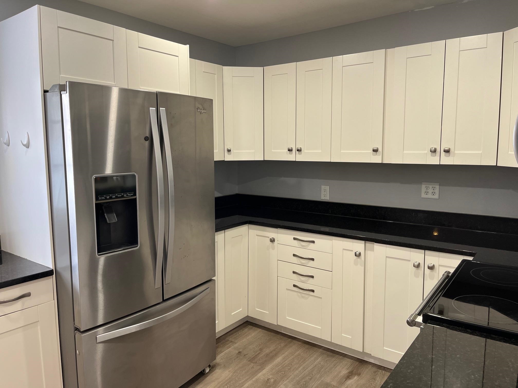 4909 Mohawk Road Rockford, IL 61107 - Photo 6 of 44 a kitchen with stainless steel appliances white cabinets and a refrigerator