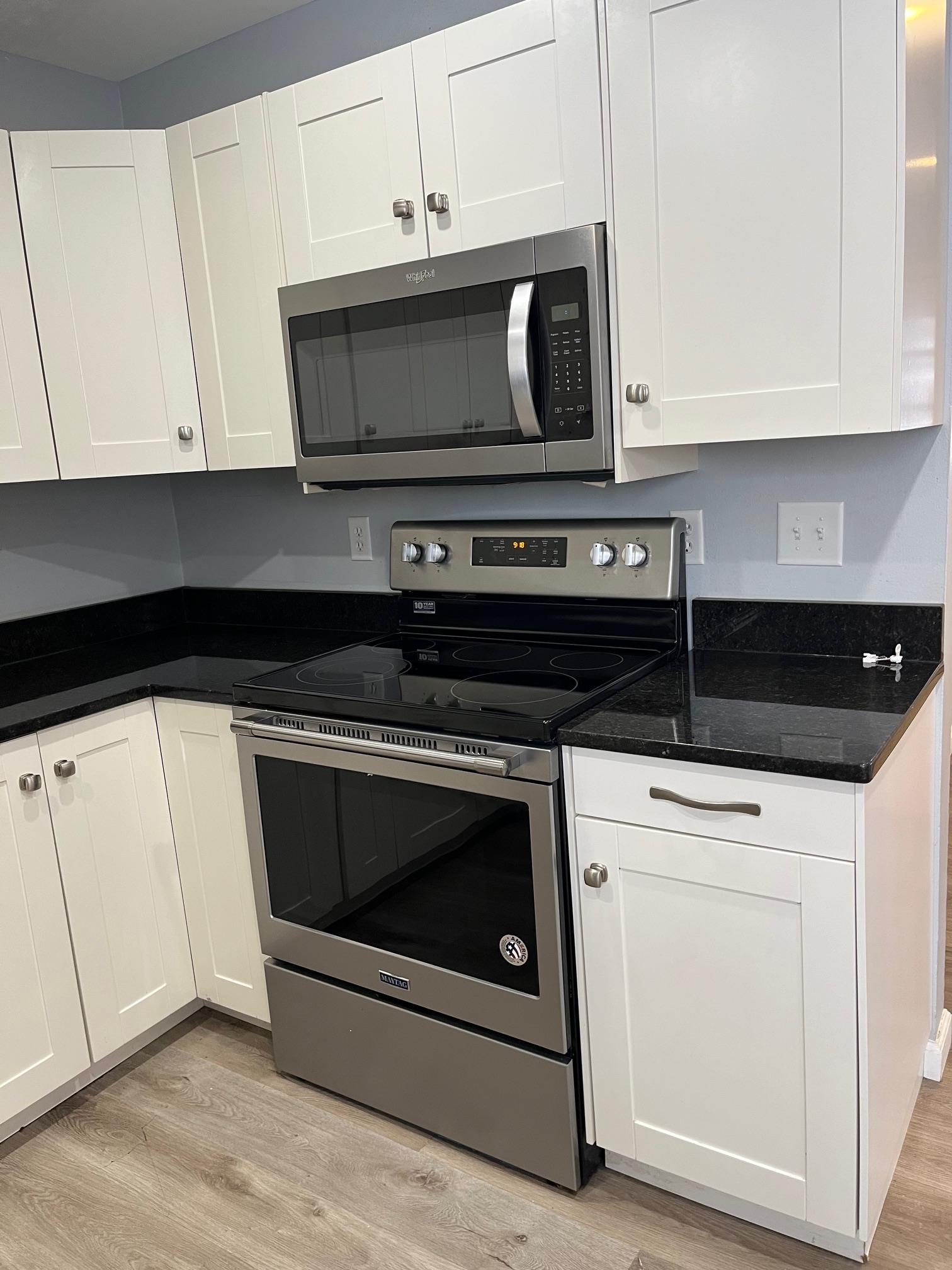 4909 Mohawk Road Rockford, IL 61107 - Photo 8 of 44 a stove top oven sitting inside of a kitchen